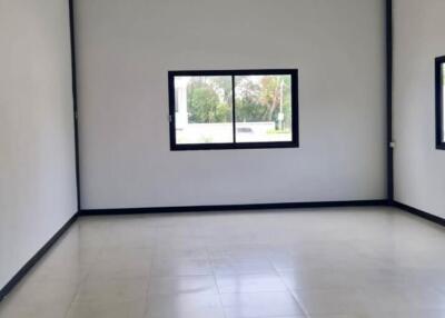 Spacious empty room with a large window