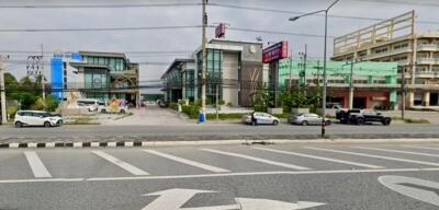 Commercial buildings along a main road with parking spaces