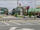 Commercial buildings along a main road with parking spaces