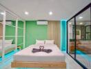 Modern bedroom with green accent wall and large bed