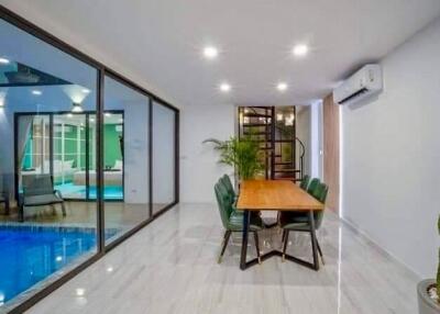 Modern dining area adjacent to indoor pool