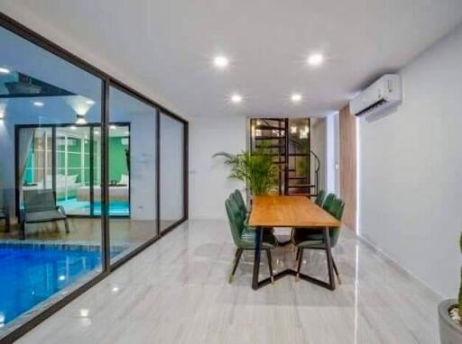 Modern dining area adjacent to indoor pool