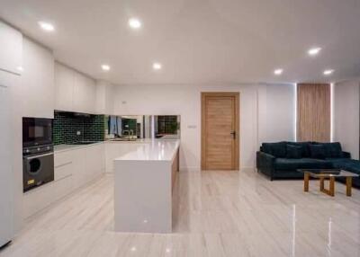 Spacious modern kitchen with island and adjacent living area