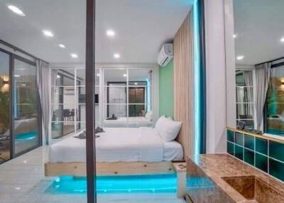 Modern bedroom with glass walls and ambient lighting