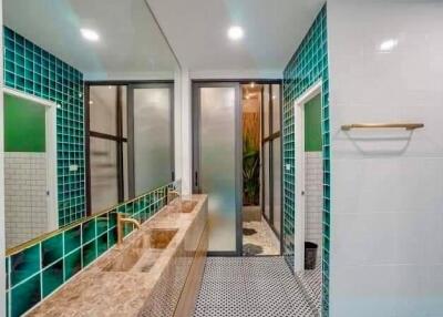 Modern bathroom with green tile accents