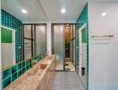 Modern bathroom with green tile accents