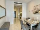 Dining area with a view of the kitchen in a modern apartment