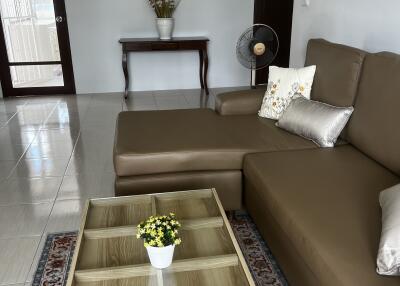 Cozy living room with brown sofa and glass coffee table