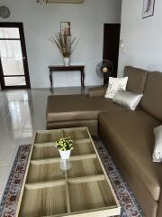 Cozy living room with brown sofa and glass coffee table