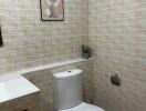 Neat bathroom with tiled walls and a modern toilet