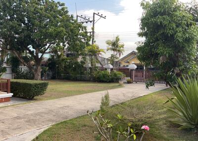 Front yard with pathway and trees