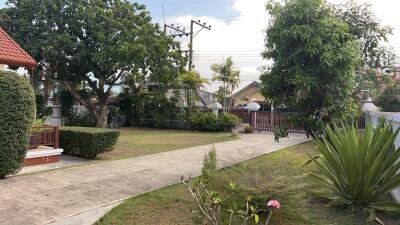 Front yard with pathway and trees