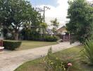 Front yard with pathway and trees