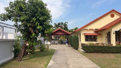 Exterior view of a residential property with a driveway and garden