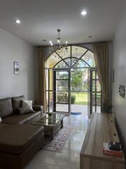 Modern living room with large window and garden view