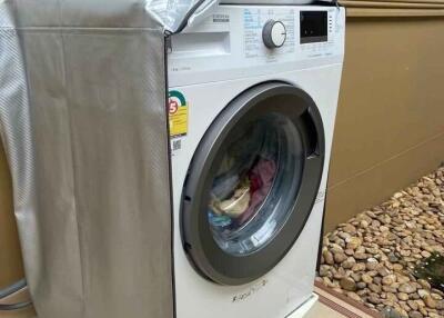 A laundry area with a washing machine