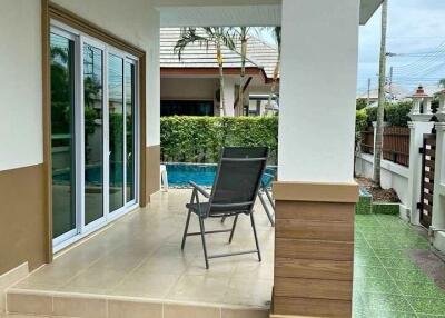 Outdoor patio with chairs near swimming pool