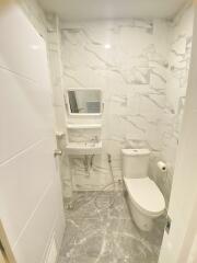 Modern bathroom with marble tiles and white fixtures