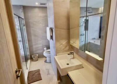 Modern bathroom with vanity mirror and glass shower enclosure