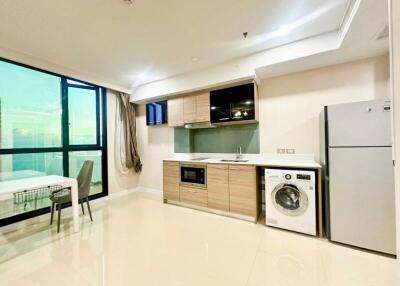 Modern kitchen with built-in appliances and nearby dining area