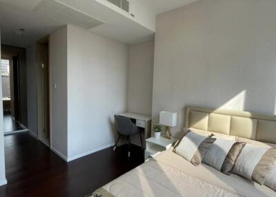 Modern bedroom with a bed, study desk, chair, and natural light