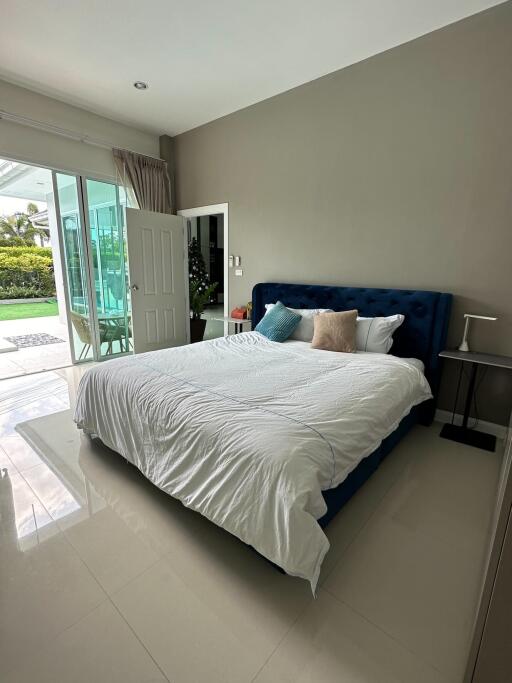 Modern bedroom with large window and garden view