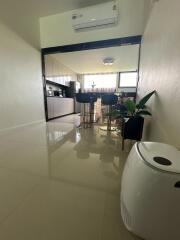 Modern kitchen area with high chairs and potted plant