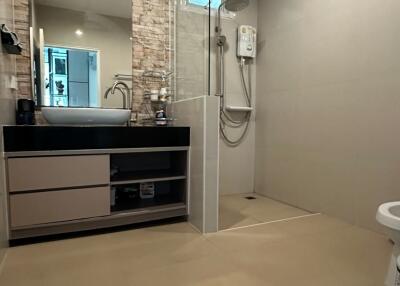 Modern bathroom with shower, sink, and countertop