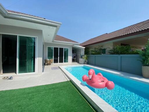 Modern backyard with swimming pool and inflatable float