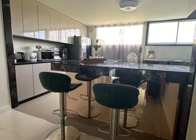 modern kitchen with bar stools and appliances