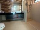 Modern bathroom with wooden accent wall and walk-in shower