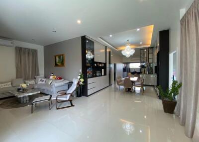 Modern living and dining area with contemporary furniture and lighting