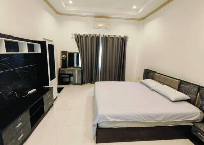 Spacious and modern bedroom with a double bed and furniture