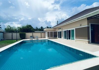 Outdoor pool area with view of the house