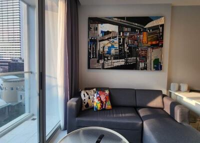 Modern living room with a balcony view and artistic wall decor