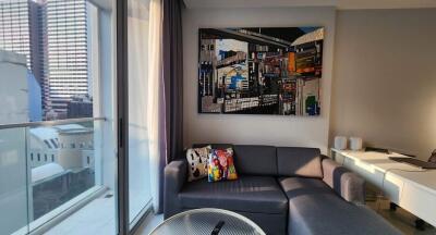 Modern living room with a balcony view and artistic wall decor