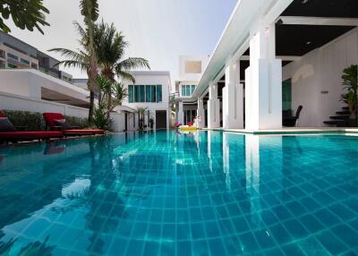 Luxurious outdoor swimming pool with modern surrounding architecture