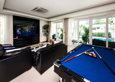 Modern living room with entertainment center and pool table