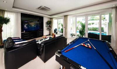 Modern living room with entertainment center and pool table