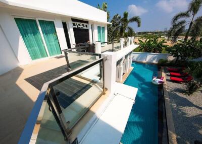Modern building exterior with pool and patio area