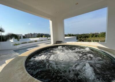 Outdoor terrace with jacuzzi and scenic view