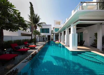 Modern house with outdoor swimming pool and lounge chairs