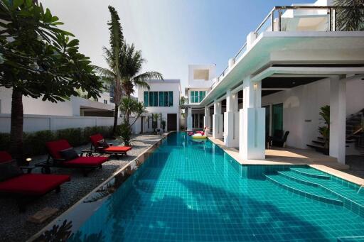 Modern house with outdoor swimming pool and lounge chairs