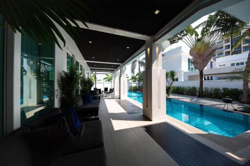 Modern outdoor patio with shaded seating area and pool