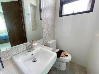 Modern bathroom with sink, mirror, and toilet