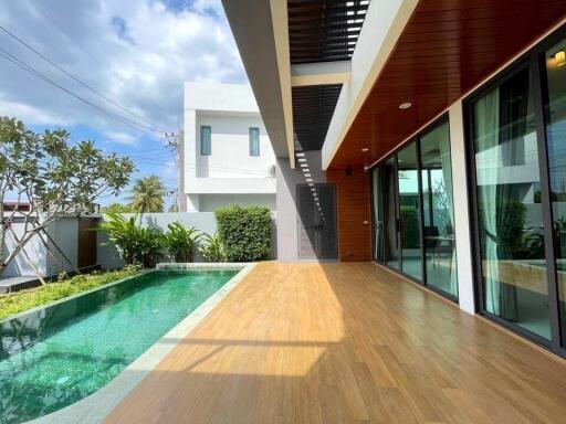 Modern outdoor area with swimming pool and wooden deck