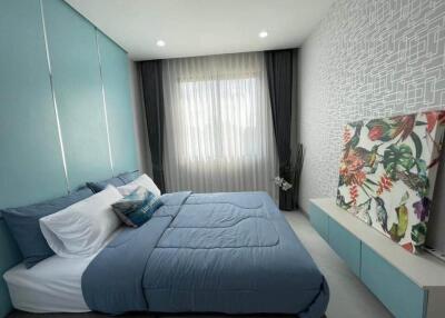 Modern bedroom with blue bedding and contemporary decor