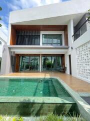 Modern two-story house with swimming pool and large windows