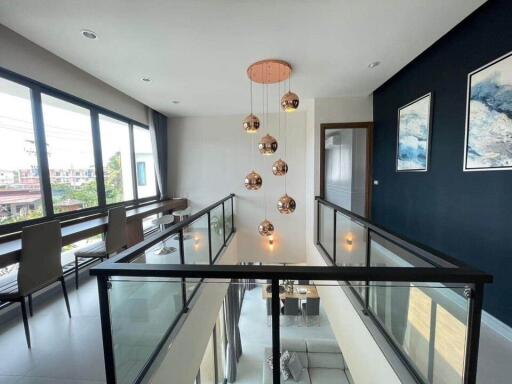 Modern mezzanine with stylish hanging lights and large windows