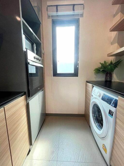 Modern laundry room with natural light and appliances